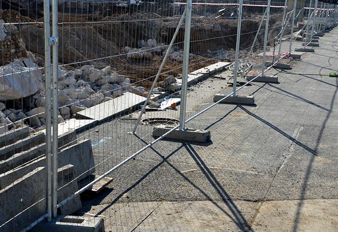 a set of temporary fence panels protecting a job site